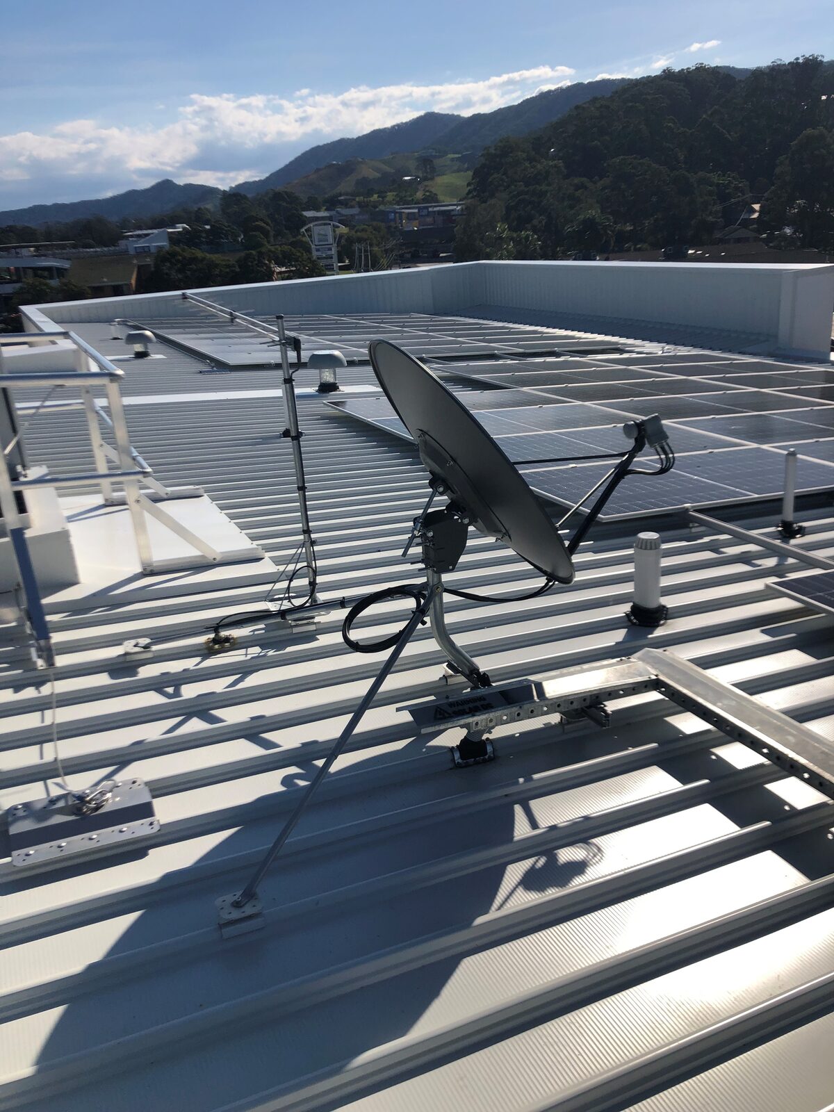 Satellite dish and reception system installed on a commercial roof on the Coffs Coast